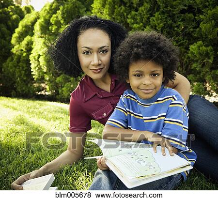 Mother and son reading books in park View Large Photo Image Stock Photo - Mother and son reading books in park. Fotosearch