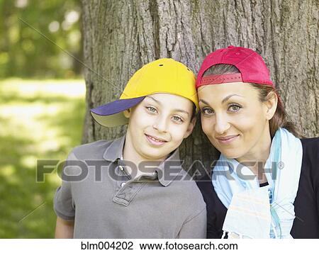 Mother and son wearing baseball caps View Large Photo Image Stock Image - Mother and son wearing baseball caps. Fotosearch