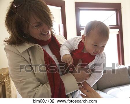 Mother holding baby girl View Large Photo Image Stock Image - Mother holding baby girl. Fotosearch