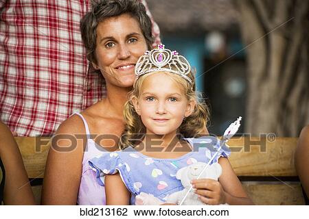 Mother holding daughter with wand and tiara View Large Photo Image Stock Image - Mother holding daughter with wand and tiara. Fotosearch