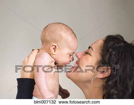 Mother holding newborn baby face to face View Large Photo Image Stock Image - Mother holding newborn baby face to face. Fotosearch