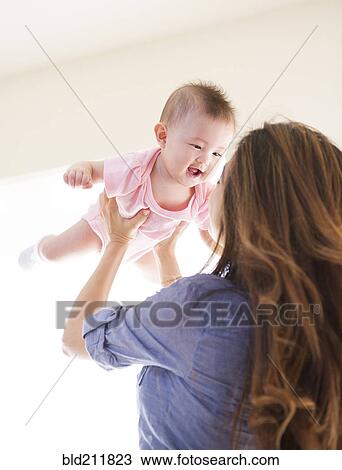 Mother playing with baby girl View Large Photo Image Stock Image - Mother playing with baby girl. Fotosearch