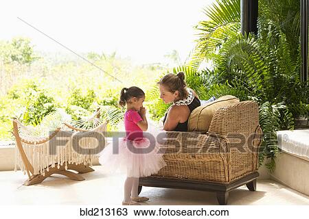 Stock Image - Mother talking to daughter in tutu. Fotosearch
