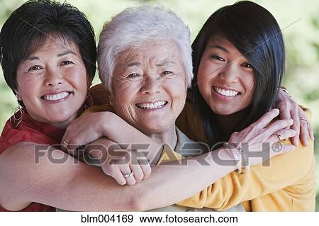 Stock Photo - Multi-generation Japanese women hugging. Fotosearch