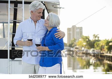 Older Caucasian couple having wine on boat deck View Large Photo Image Stock Photo - Older Caucasian couple having wine on boat deck. Fotosearch