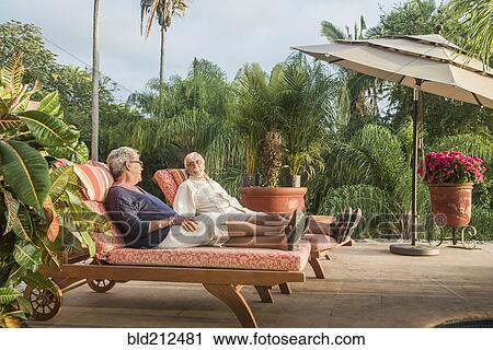 Older Caucasian couple relaxing by pool View Large Photo Image Stock Image - Older Caucasian couple relaxing by pool. Fotosearch