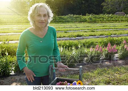 Older Caucasian woman smiling on farm View Large Photo Image Stock Image - Older Caucasian woman smiling on farm. Fotosearch
