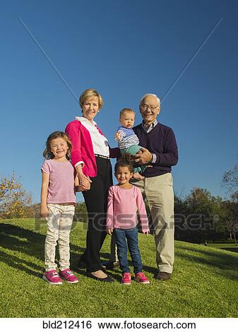 Older couple and grandchildren smiling together outdoors View Large Photo Image Stock Photograph - Older couple and grandchildren smiling together outdoors. Fotosearch