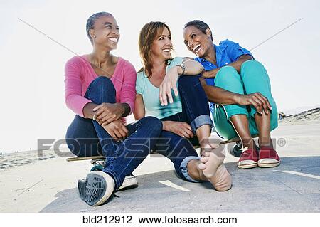 Older women sitting on skateboard on beach View Large Photo Image Stock Image - Older women sitting on skateboard on beach. Fotosearch