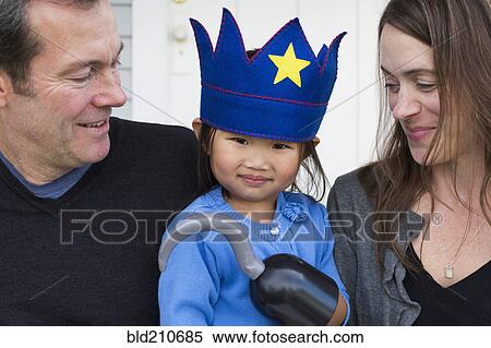 Parents holding daughter with hook and crown View Large Photo Image Stock Photography - Parents holding daughter with hook and crown. Fotosearch