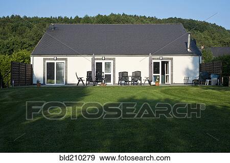 Stock Photo - Patio and lawn outside house. Fotosearch