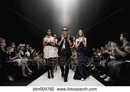 Stock Image - People clapping on runway in fashion show. Fotosearch