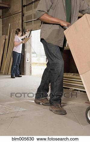 Stock Image - People working in warehouse. Fotosearch