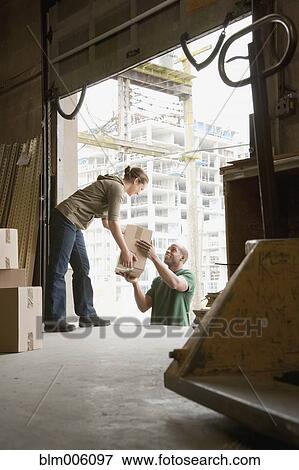 Stock Photo - People working on warehouse loading dock. Fotosearch