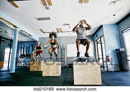 Stock Photo - People working out in gym. Fotosearch