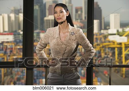 Stock Image - Pilipino businesswoman with hands on hips. Fotosearch
