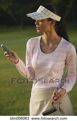 Pilipino golfer text messaging on cell phone View Large Photo Image Stock Image - Pilipino golfer text messaging on cell phone. Fotosearch