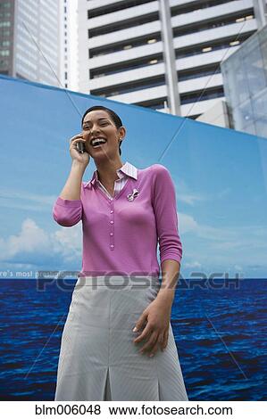 Stock Photo - Pilipino laughing and talking on cell phone. Fotosearch