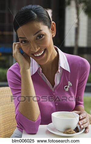 Pilipino woman drinking coffee in cafe View Large Photo Image Stock Photography - Pilipino woman drinking coffee in cafe. Fotosearch