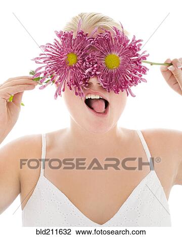 Stock Image - Portrait of silly woman covering eyes with flowers. Fotosearch