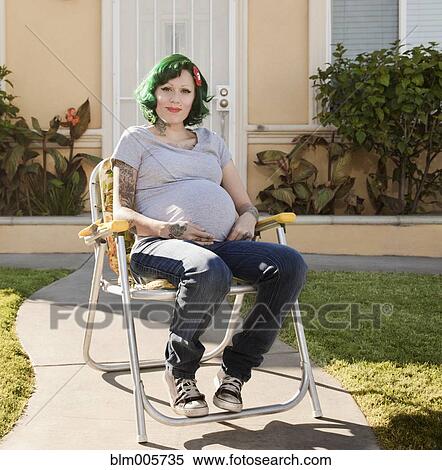 Pregnant, alternative Hispanic woman sitting in lawn chair View Large Photo Image Stock Photography - Pregnant, alternative Hispanic woman sitting in lawn chair. Fotosearch