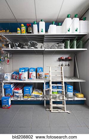 Stock Image - Rack with gardening and building supplies at a hardware store. Fotosearch