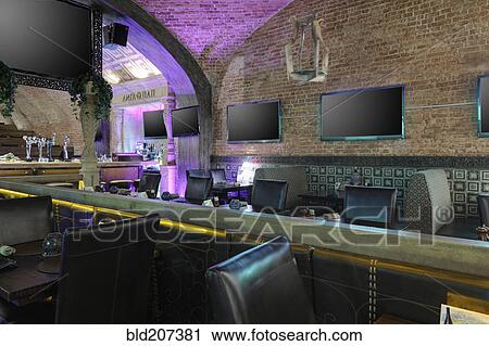Stock Image - Raw of TV screens on restaurant wall. Fotosearch