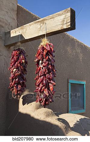 Stock Image - Red Chili Peppers Hanging Outdoors. Fotosearch