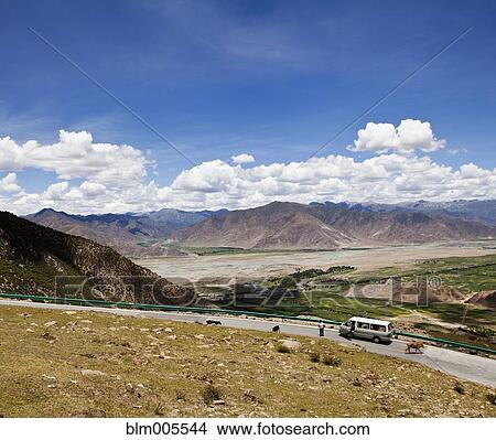 Road and remote valley with mountains in the distance View Large Photo Image Picture - Road and remote valley with mountains in the distance. Fotosearch