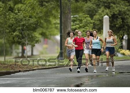 Runners jogging in park View Large Photo Image Stock Photo - Runners jogging in park. Fotosearch