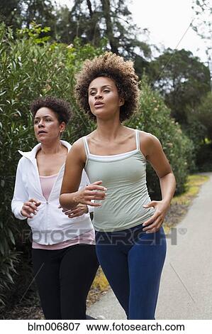 Stock Photo - Runners jogging in park. Fotosearch