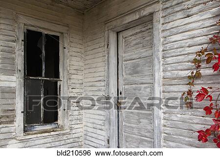 Stock Photograph - Rustic door, siding and window of wooden house. Fotosearch