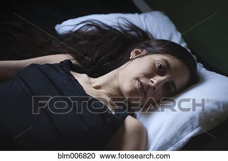 Sad mixed race woman laying in bed View Large Photo Image Stock Image - Sad mixed race woman laying in bed. Fotosearch