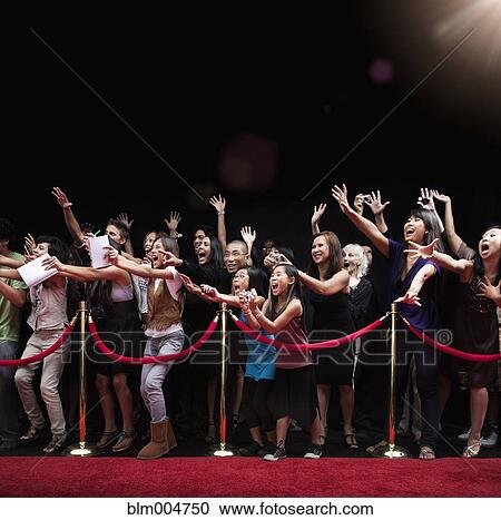 Stock Image - Screaming fans on the red carpet. Fotosearch