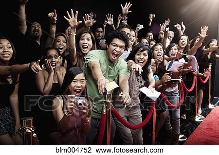 Stock Image - Screaming fans on the red carpet. Fotosearch