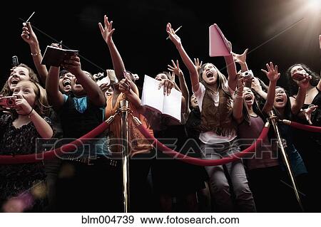 Stock Photo - Screaming fans on the red carpet. Fotosearch