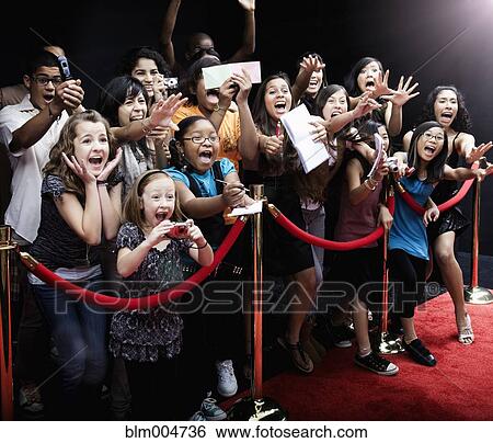 Stock Photograph - Screaming fans on the red carpet. Fotosearch