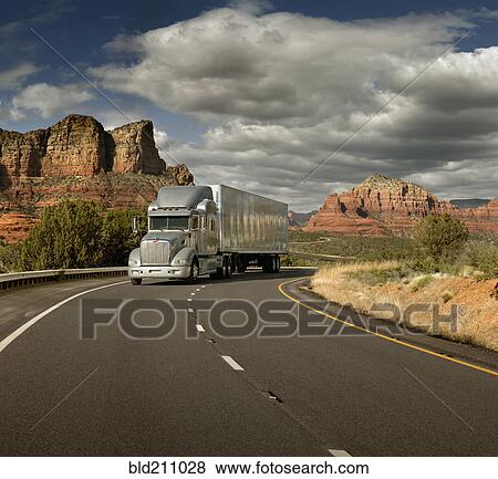 Stock Photo - Semi truck driving through desert, Sedona, Arizona, United States. Fotosearch