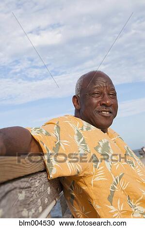 Senior African man relaxing on bench View Large Photo Image Stock Image - Senior African man relaxing on bench. Fotosearch