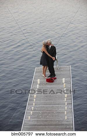 Senior Caucasian couple dancing on pier View Large Photo Image Stock Photo - Senior Caucasian couple dancing on pier. Fotosearch