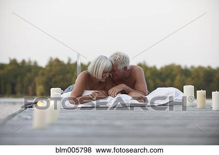 Senior Caucasian couple sleeping on pier View Large Photo Image Stock Photo - Senior Caucasian couple sleeping on pier. Fotosearch
