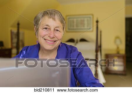 Stock Image - Senior Caucasian woman using laptop. Fotosearch