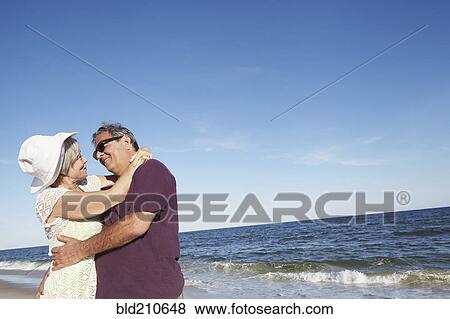 Stock Photo - Senior couple dancing on tropical beach. Fotosearch