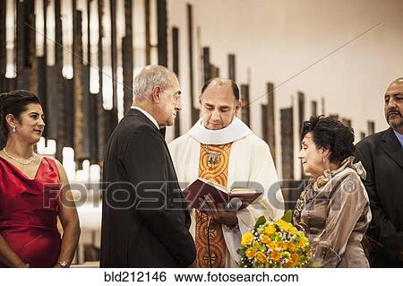 Stock Photograph - Senior couple exchanging vows at wedding. Fotosearch