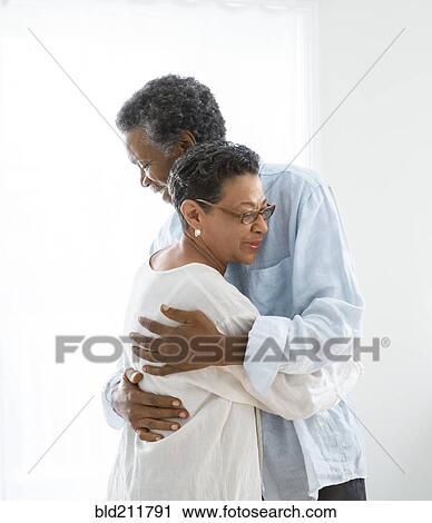 Senior couple hugging indoors View Large Photo Image Stock Image - Senior couple hugging indoors. Fotosearch