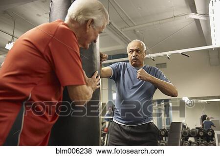 Stock Photo - Senior men working out in health club. Fotosearch