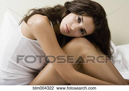 Stock Image - Sensual Middle Eastern woman on bed. Fotosearch