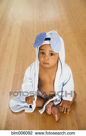 Stock Image - Serious African American boy in towel. Fotosearch