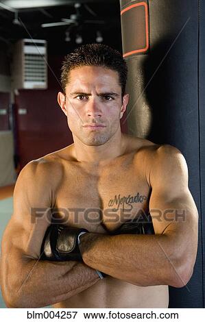Serious Hispanic boxer standing with arms crossed View Large Photo Image Stock Photo - Serious Hispanic boxer standing with arms crossed. Fotosearch