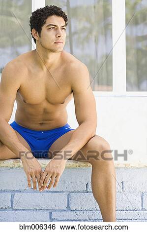 Serious Latin man in bathing suit View Large Photo Image Stock Photograph - Serious Latin man in bathing suit. Fotosearch